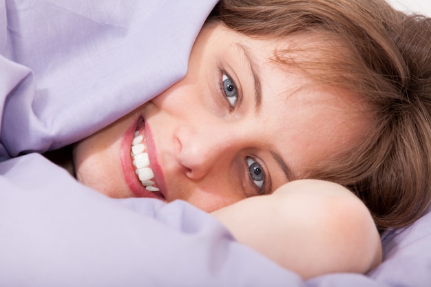 Smiling woman in bed