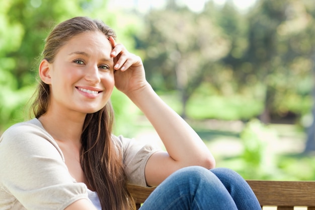 Smiling woman on a bench in the park