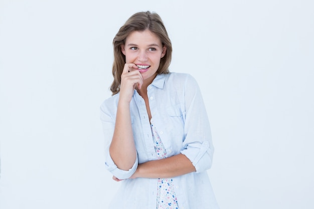 smiling woman biting her finger