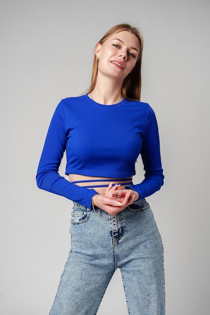 Smiling woman in black top against gray background