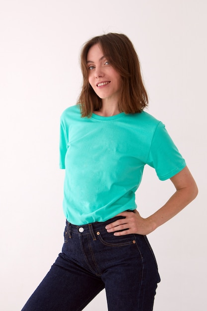 Smiling woman in casual outfit standing in studio