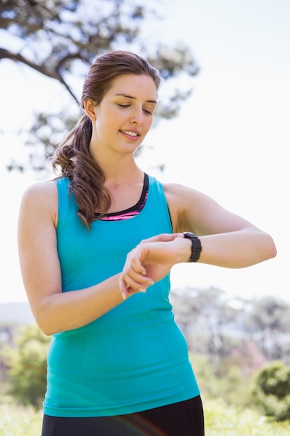 Smiling woman checking her watch