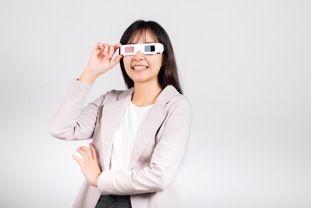 Smiling woman confidence wearing 3d cinema movie glasses red and blue isolated white background, Asian happy portrait beautiful young female in television film studio shot, copy space