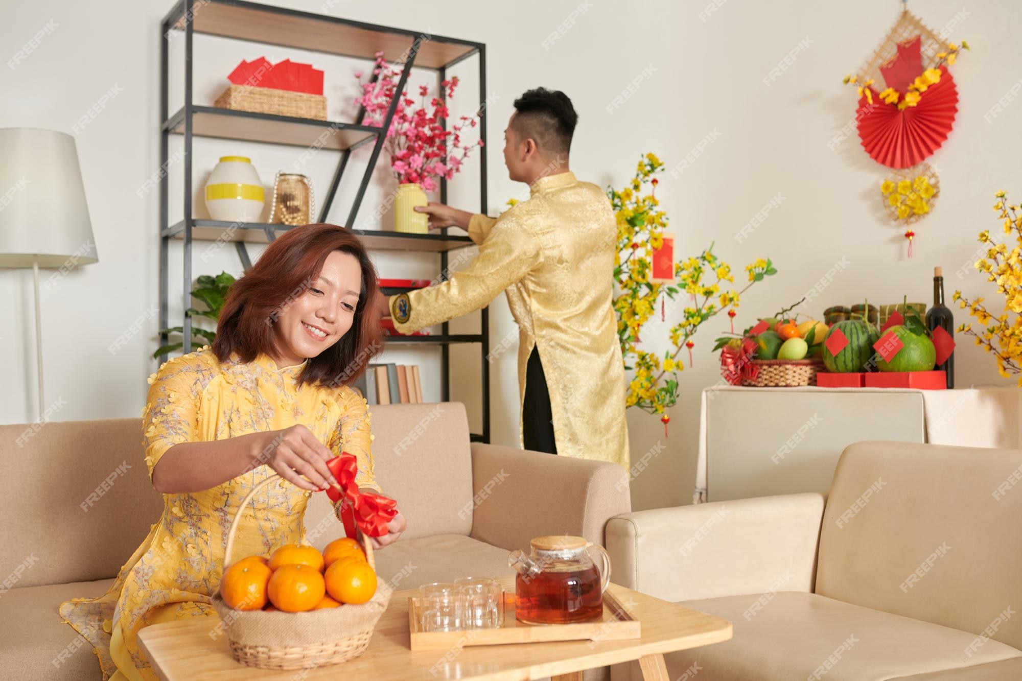 Premium Photo | Smiling woman decorating basket of mandarins with ...