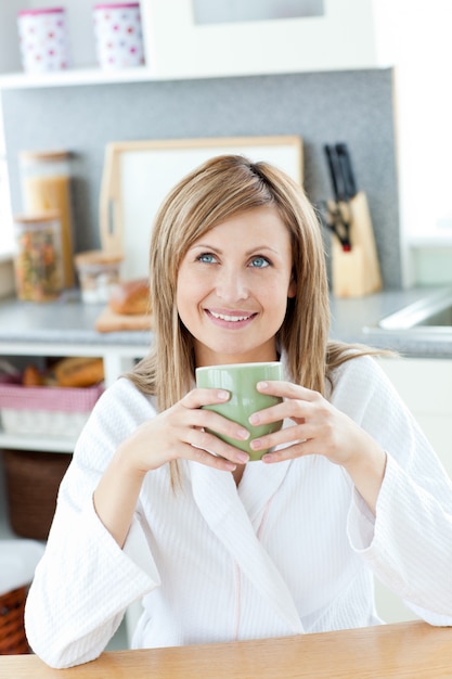 Smiling woman drinking something