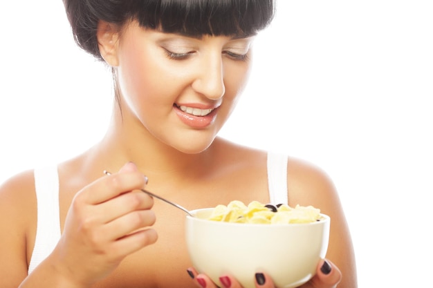 Smiling woman eating muesli
