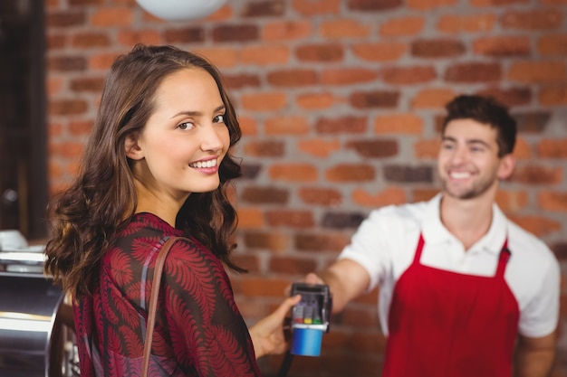 Smiling woman handing a pin terminal 