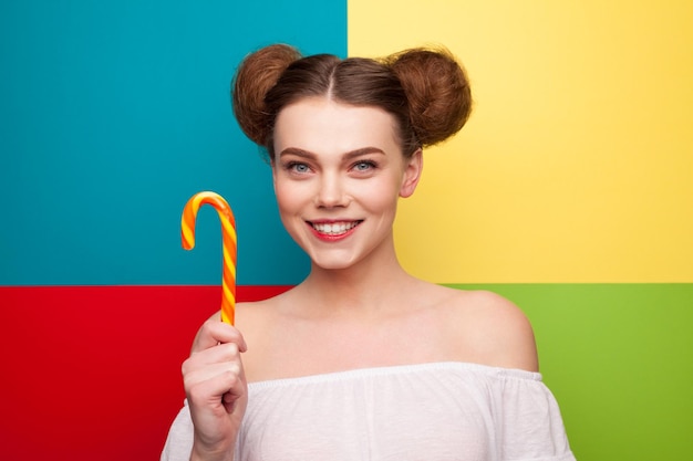 Smiling woman holding candy cane