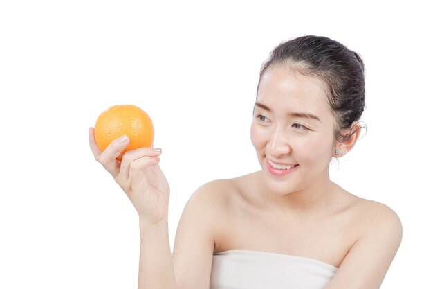 Smiling woman holding a Orange