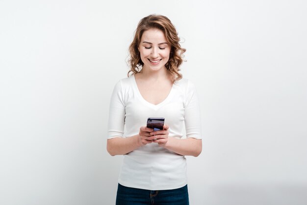 Smiling woman holding a phone in her hand
