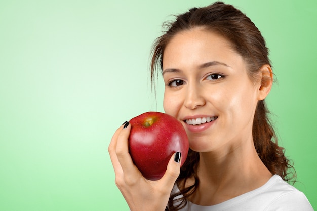 Smiling woman holding red apple