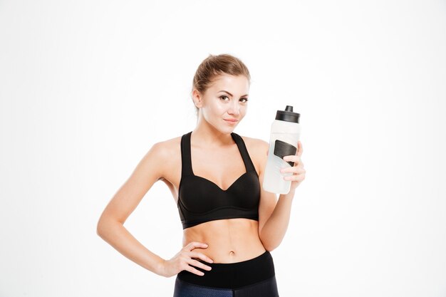 Smiling woman holding shaker with water isolated    