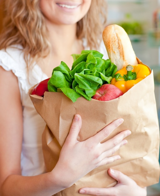 Smiling woman holding a shopping bag 