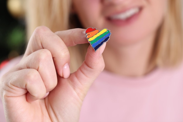 Smiling woman holding small lgbt icon Communities of sexual minorities concept