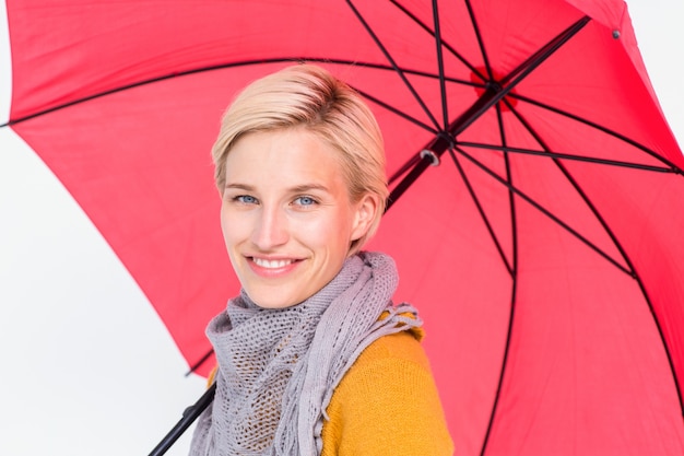 Smiling woman holding an umbrella