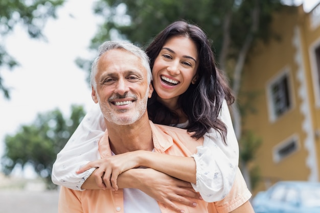 Smiling woman hugging man from behind