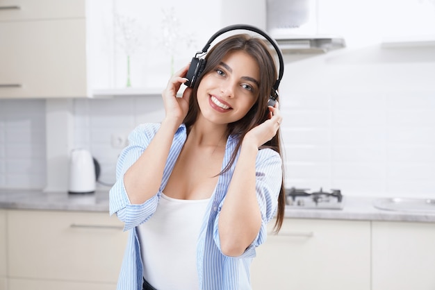 Smiling woman listening musin in headphone