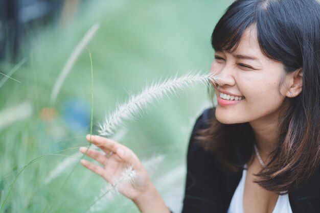写真 植物を見ている笑顔の女性