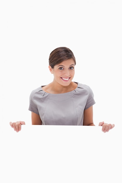 Smiling woman looking over blank wall