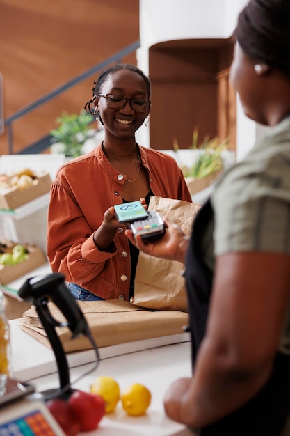 Smiling woman making nfc payment