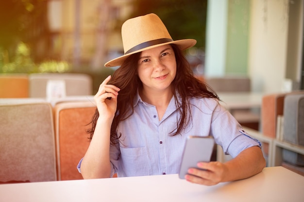 Smiling woman making selfie outsidesunlight on background