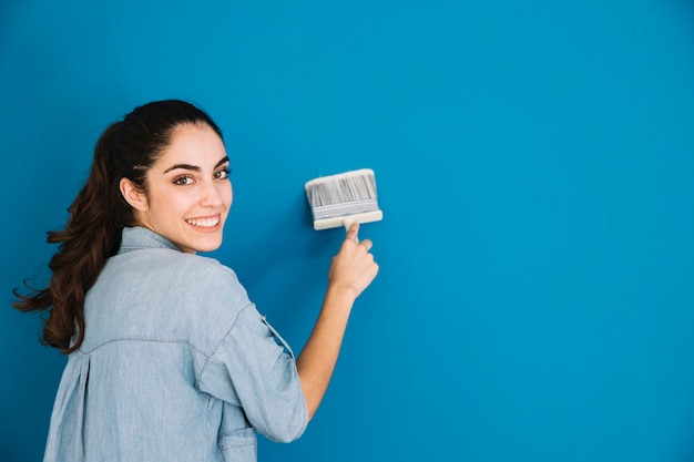 Smiling woman painting