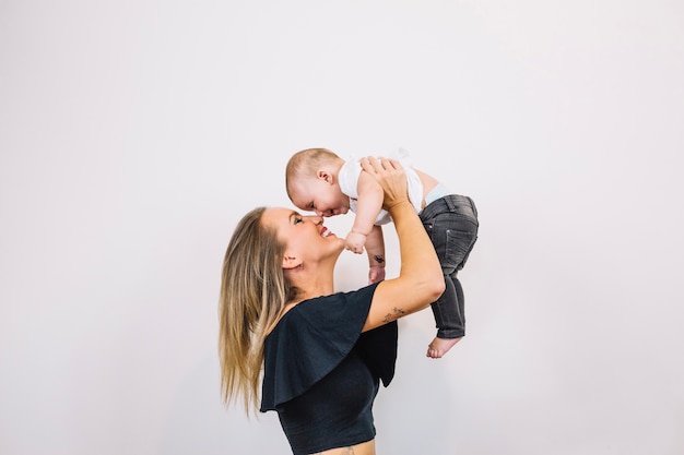 Smiling woman playing with baby