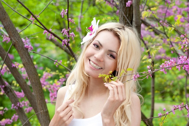 Smiling woman portrait in blossom park