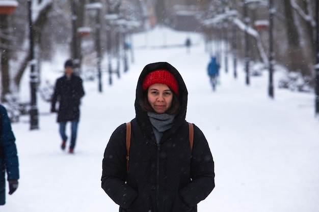 Smiling woman portrait in winter outfit at city park