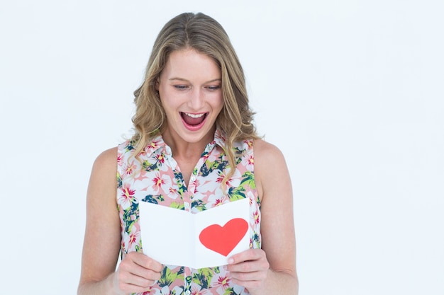 Smiling woman reading love letter 