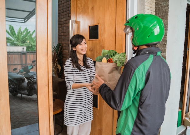 Smiling Woman Receiving Grocery Delivery At Home