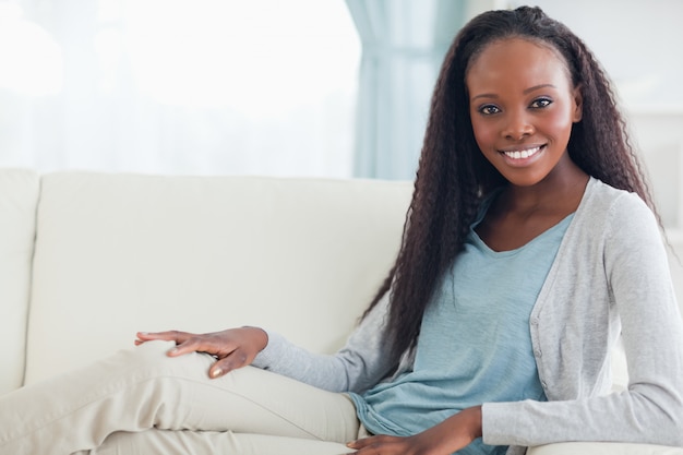 Smiling woman relaxing on sofa