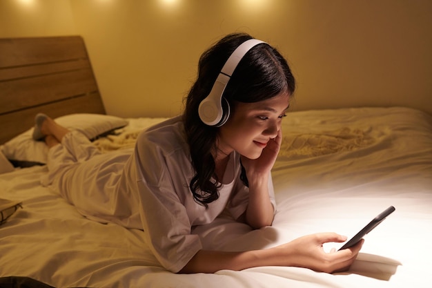 Smiling Woman Resting on Bed