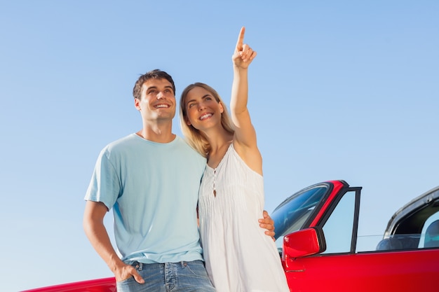 Smiling woman showing something to her handsome boyfriend