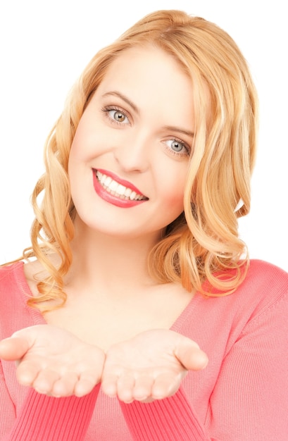 smiling woman showing something on the palms of her hands