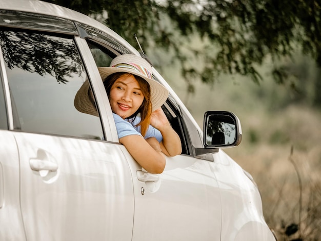 Smiling woman sitting in car