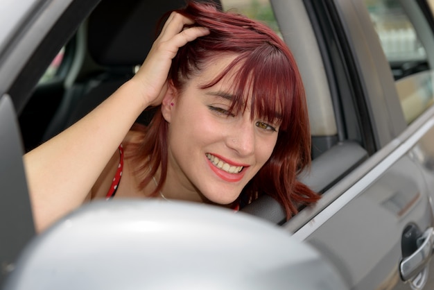 Smiling woman sitting in car