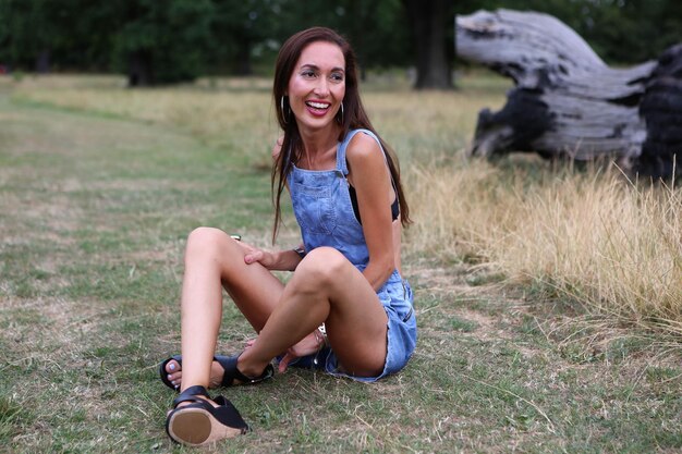 Smiling woman sitting on field