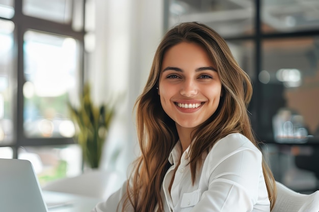 Smiling woman sitting at her desk in office happy business woman sitting in office