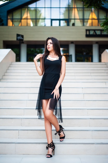 Smiling woman in slim black dress