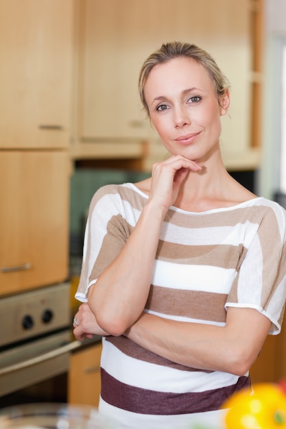 Smiling woman standing in kitchen