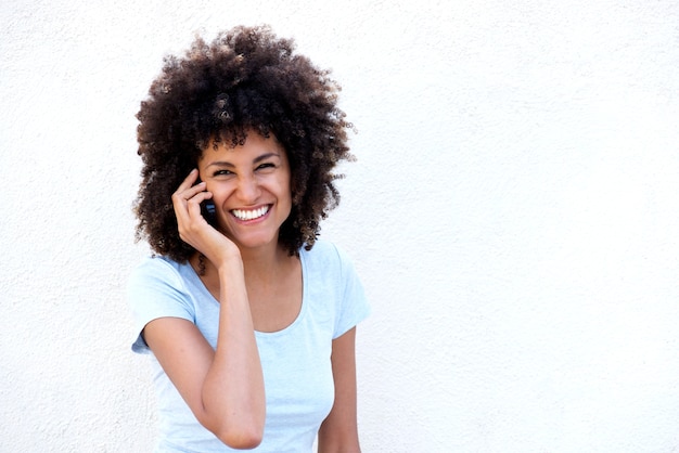 Smiling woman talking on cellphone isolated on white background