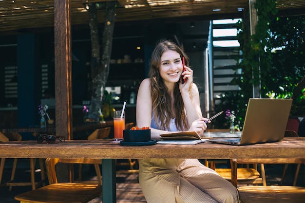 Smiling woman talking on smartphone