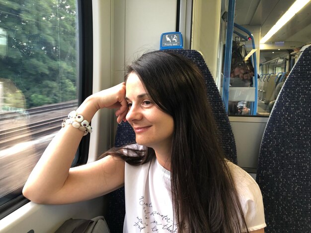 Smiling woman traveling in train