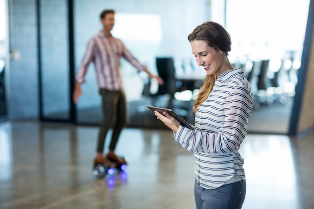 Smiling woman using digital tablet