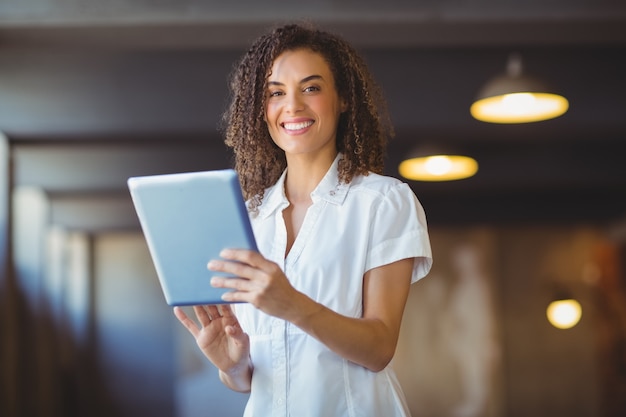 Smiling woman using a digital tablet