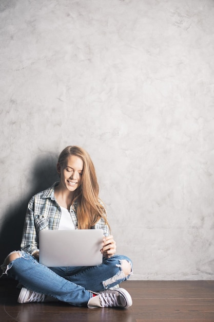 Smiling woman using laptop