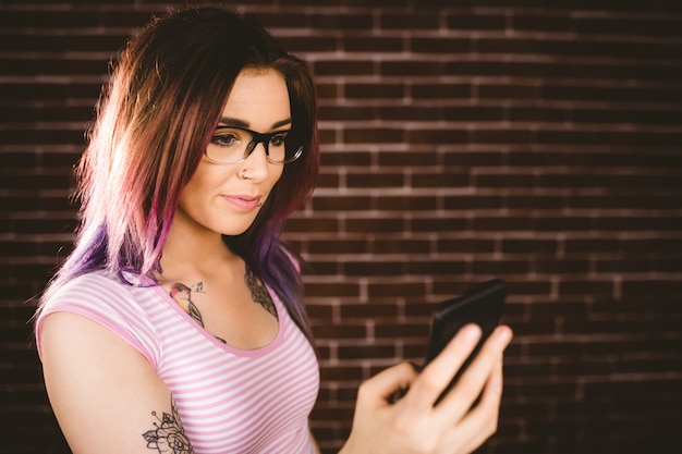 Smiling woman using mobile phone