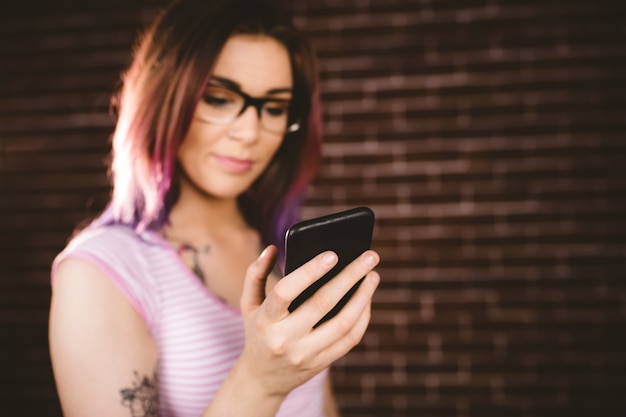 Smiling woman using mobile phone