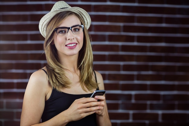 Smiling woman using smartphone